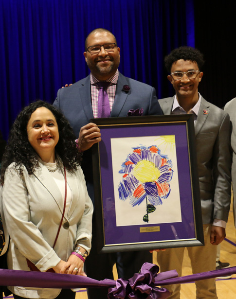 Ana's Family posing with artwork