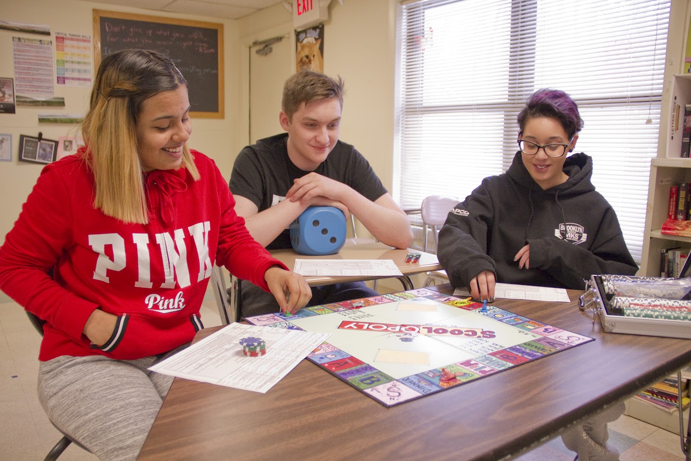 Students playing a game of S'Cool-Opoly to help them learn math