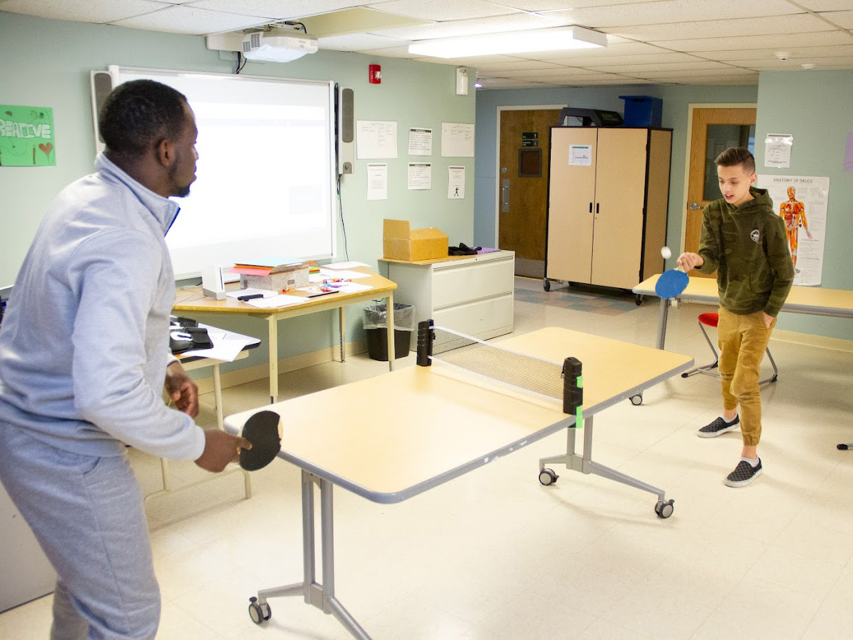 Students unwind playing a game of ping pong